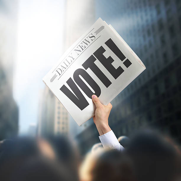 istock Holding Newspaper with Vote 495716547