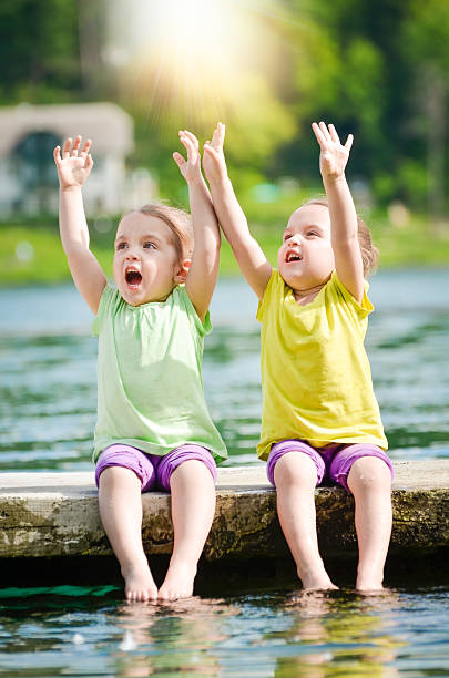 istock Twing girls exercising on a lake shore 495718859