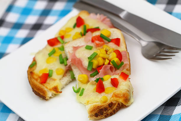 istock Toast with mozzarella, ham, red pepper and sweetcorn 495720593