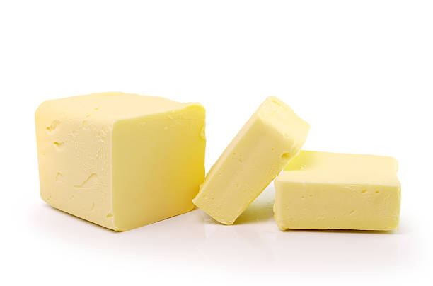 istock Stick of butter, cut, isolated on white. 495720627
