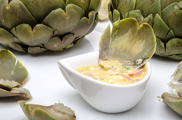 Composition with an artichoke's leaf dipped in a vinaigrette