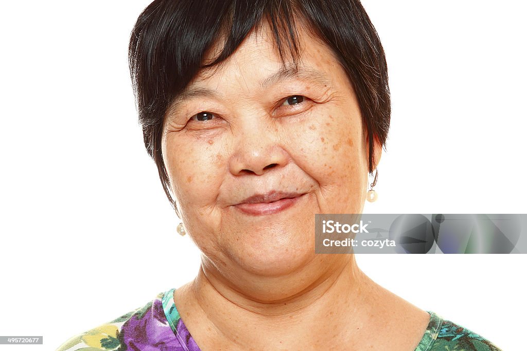 Happy 60s Senior Asian Woman on white background Chinese Ethnicity Stock Photo