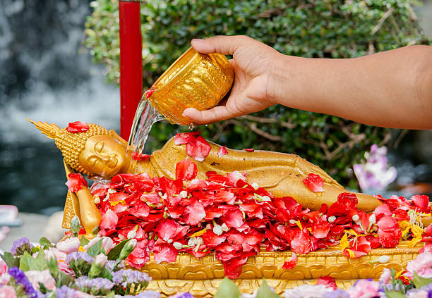 Pouring water over Buddha stock photo