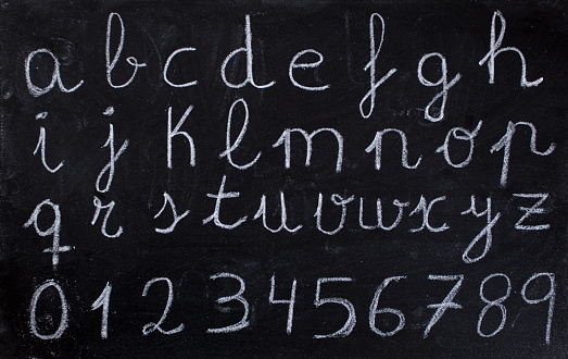 The Alphabet and number written on black chalkboard