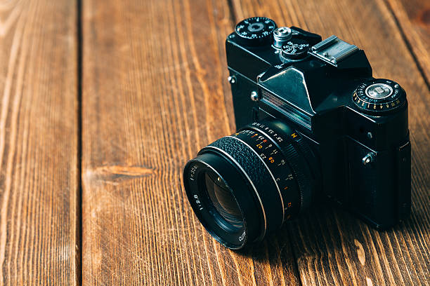 istock Old camera and on wooden table 495726584