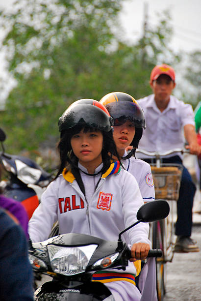 Traffic vietnam Hanoi, Vietnam - November 8, 2010: two girls on a scooter in Vietnam vietnamese girls for sale stock pictures, royalty-free photos & images