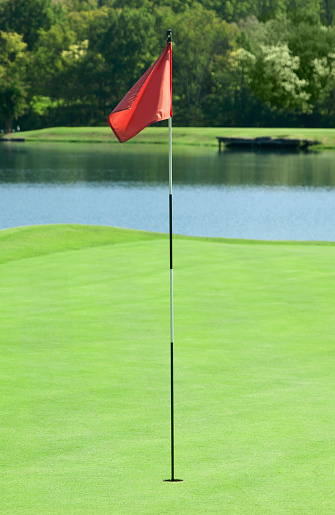 Golf flag marking the hole on a golf course green.