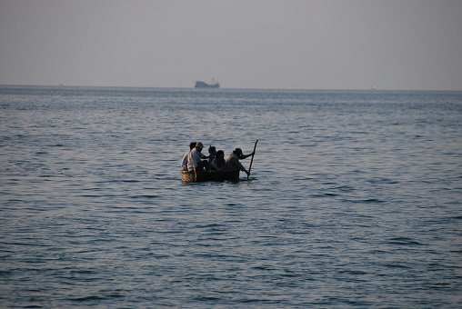 Phu Quo, Vietnam - November 12, 2010: 5 unidentifiable refugees on a very small boat 
