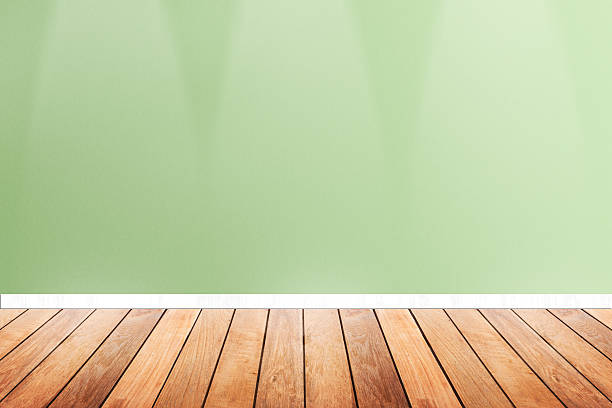 istock wood floor and green pastel wallpaper with down light .interior 495732210