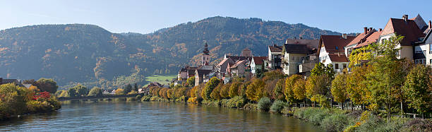 panorama,cityscape of frohnleiten on the river mur, styria,austria panorama of city frohnleiten,in styria,austria.autumnal colored trees and blue sky in october frohnleiten stock pictures, royalty-free photos & images