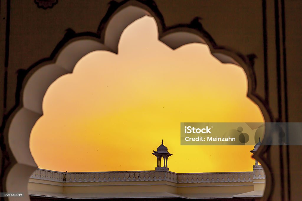 Sunset with view to a top of a small temple Sunset with view to a top of a small temple in Jaipur through a gate Art And Craft Stock Photo