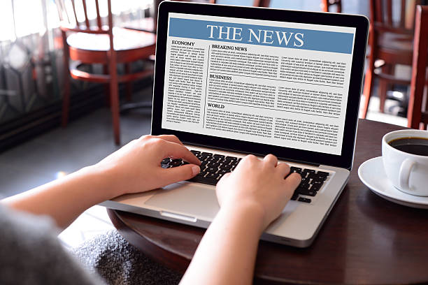 istock Reading news with laptop 495734467