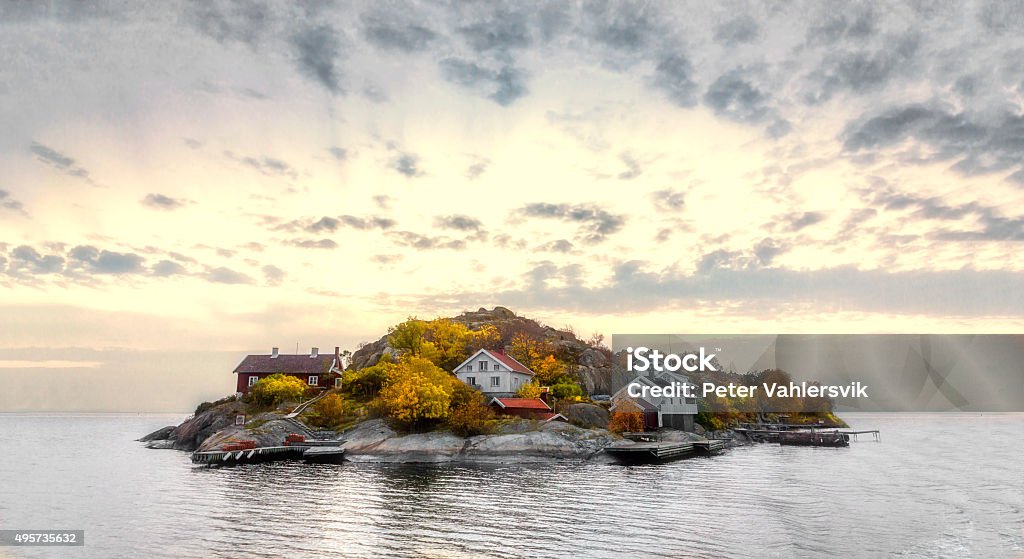 Island in autumn colors Island in swedish archipelago under sunset light and with autumn colors Sweden Stock Photo