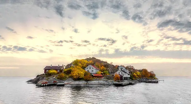 Island in swedish archipelago under sunset light and with autumn colors