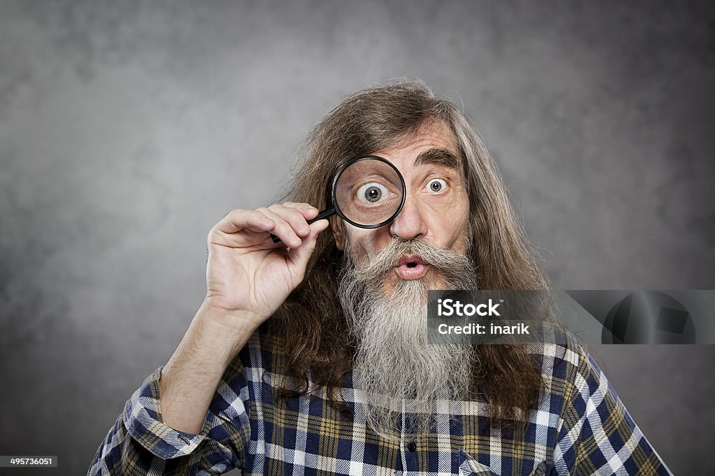 Senior old man looking through zoom magnifying glass, vision loss Senior old man looking through zoom magnifying glass. Funny elder amazement investigation or test vision loss Magnifying Glass Stock Photo