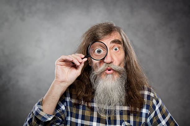 Senior old man looking through zoom magnifying glass, vision loss Senior old man looking through zoom magnifying glass. Funny elder amazement investigation or test vision loss large eyes stock pictures, royalty-free photos & images