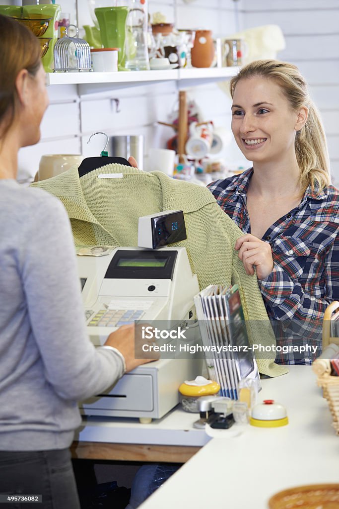 Customer Buying Clothing In Charity Shop Clothing Stock Photo