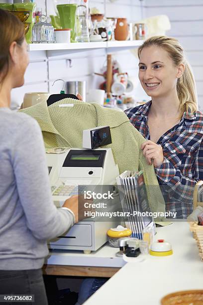 Customer Buying Clothing In Charity Shop Stock Photo - Download Image Now - Clothing, Old, Rack