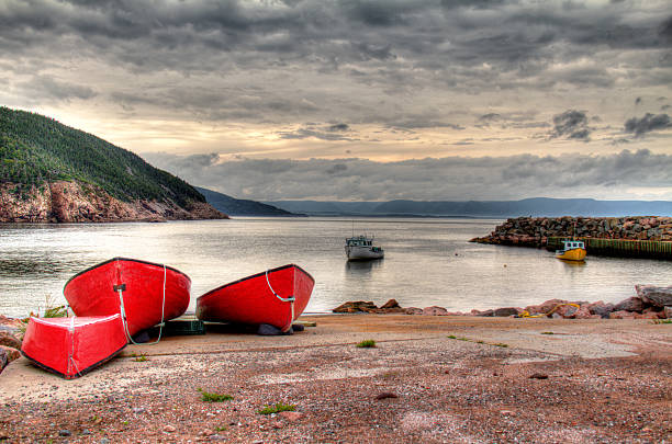 Red Fishing Boats on Cabot Trail HDR image of Red Fishing Boats on in a little fishing village on the shores of Cabot Trail, Cape Breton Island, Nova Scotia, Canada cabot trail stock pictures, royalty-free photos & images