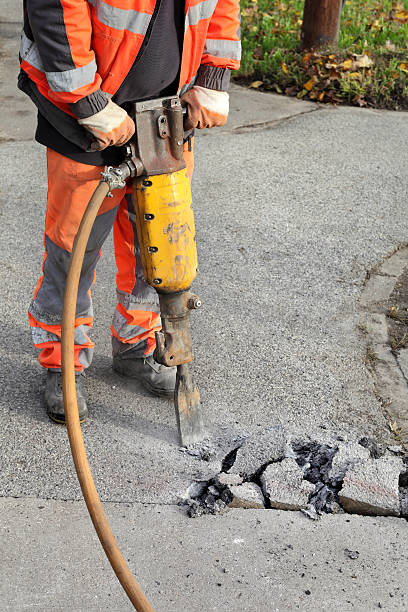 istock Asphalt demolishing, worker and jackhammer 495738210