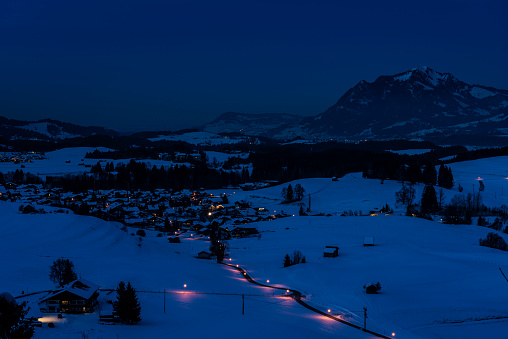 european alps in winter at blue hour