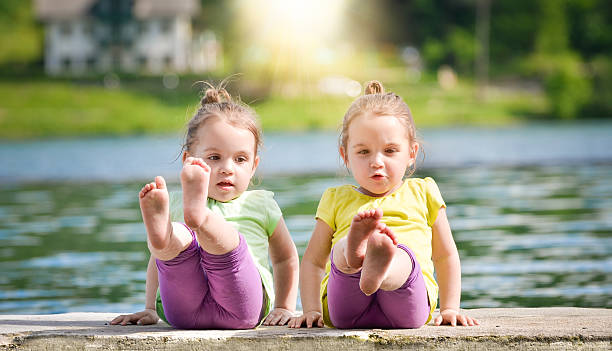 istock Twin girls exercising on a lake shore 495738877