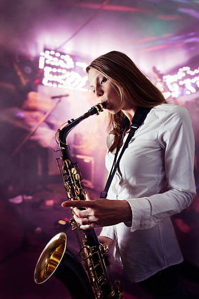 istock young beautiful woman with saxophone 495739051