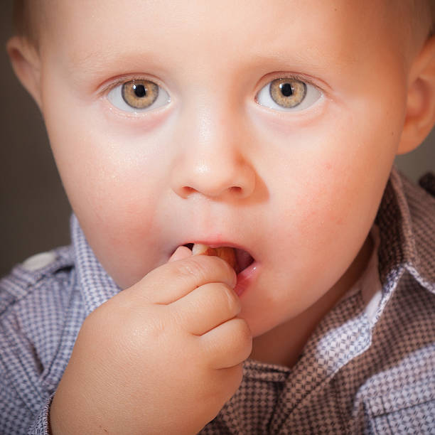 istock Cute baby boy eating something 495739275