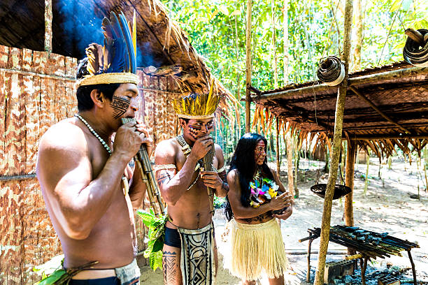 istock Native Brazilian group playing wooden flute 495740286