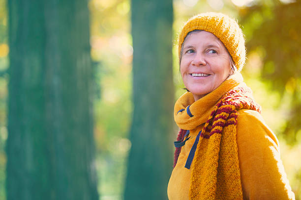 istock woman in park in the fall 495740288