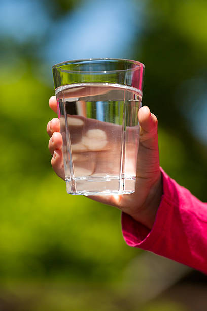 istock Child hand with glass of water 495745525
