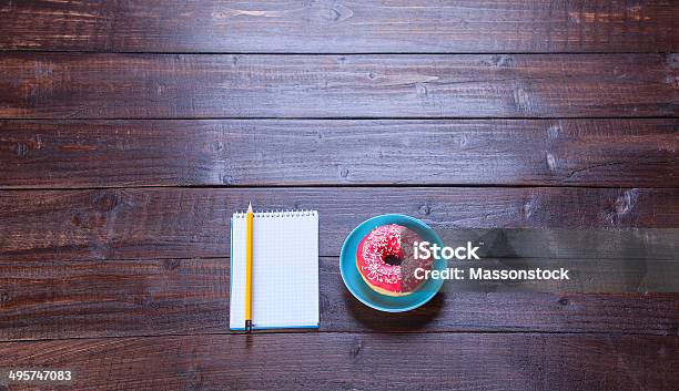 Notebook Donut And Pencil On Wooden Table Stock Photo - Download Image Now - Blank, Book, Breakfast