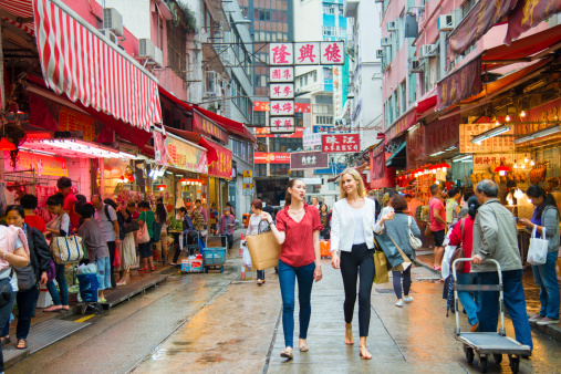 Two young woman shopping market district of Hong Kong