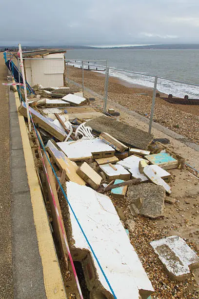 Smashed by storms, damaged beach huts. After the February 14 2014 Valentineâs Day Storm, Milford on Sea, Hampshire, England, UK