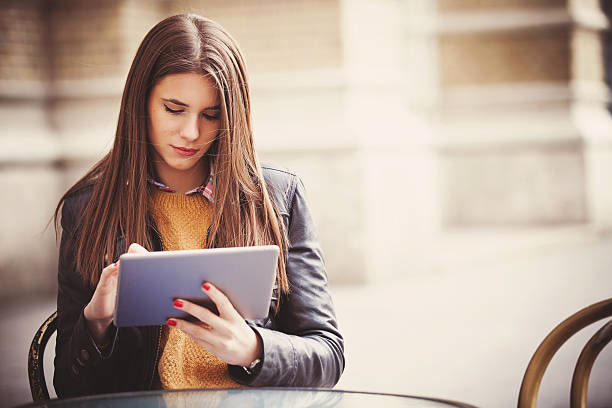 istock Young woman sitting in the cafe with digital tablet 495750822