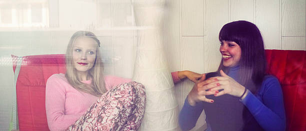 istock Best friends laughing, sitting on the sofas 495750978