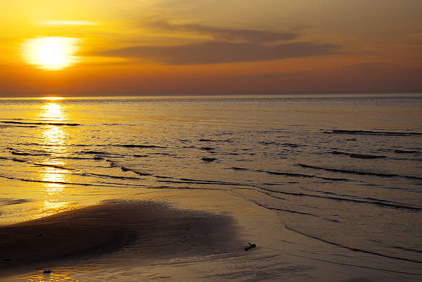 istock Beautiful orange blue sunset at Baltic sea with sun left 495751325