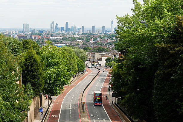 istock Double-decker bus on a road with London skyline 495752922