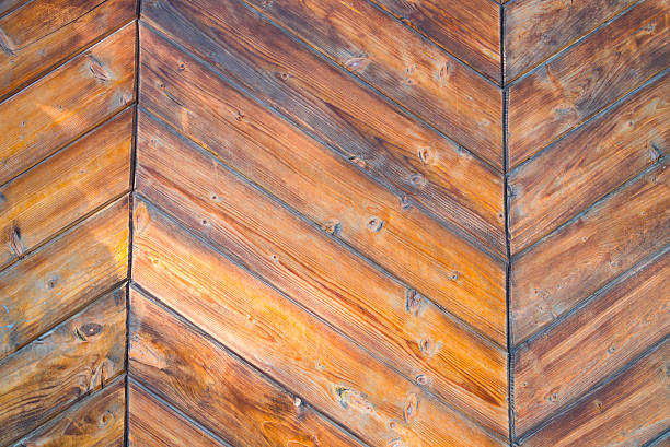Close up of  weathered and textured boards on an old wooden farm door.