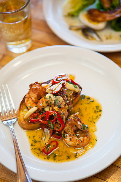 istock pancetta-wrapped white shrimp with a glass of chardonnay 495754448