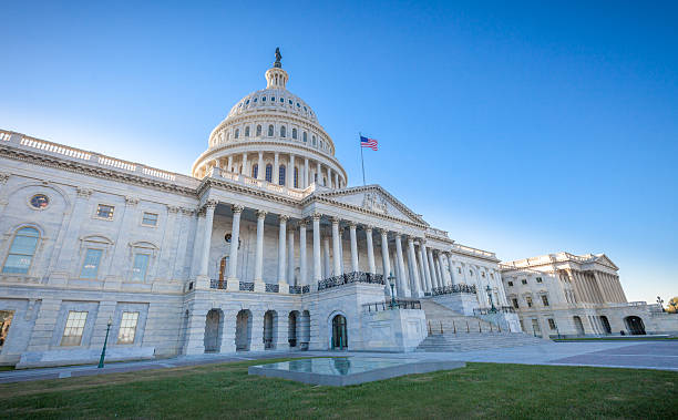 United States Capitol East Facade at angle Low angled view of the U.S. Capitol East Facade Front in Washington, DC. senate stock pictures, royalty-free photos & images