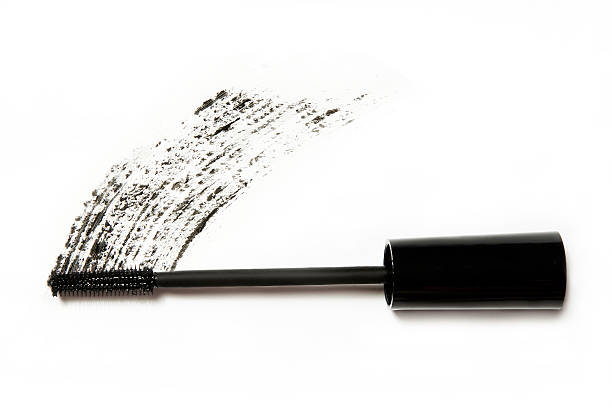 black mascara applicator on white background still life make up. black mascara applicator package with drawn trace on white background woman mascara smudged stock pictures, royalty-free photos & images