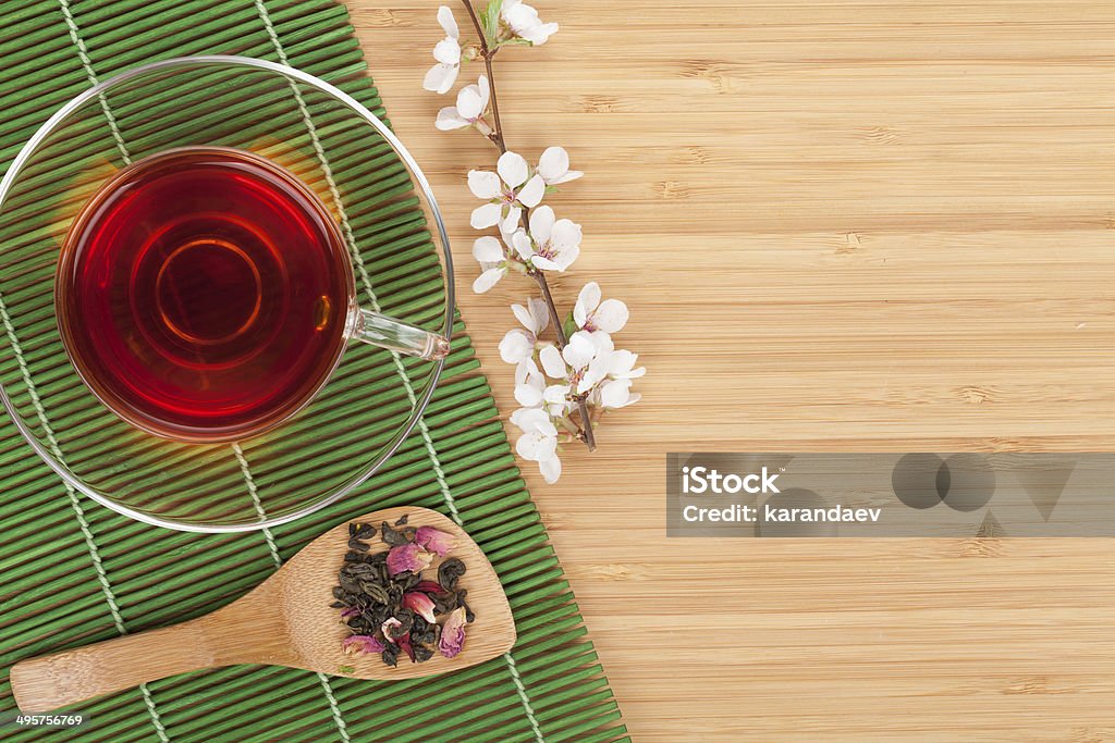 Japanese green tea and sakura branch Japanese green tea and sakura branch over bamboo table with copy space Above Stock Photo