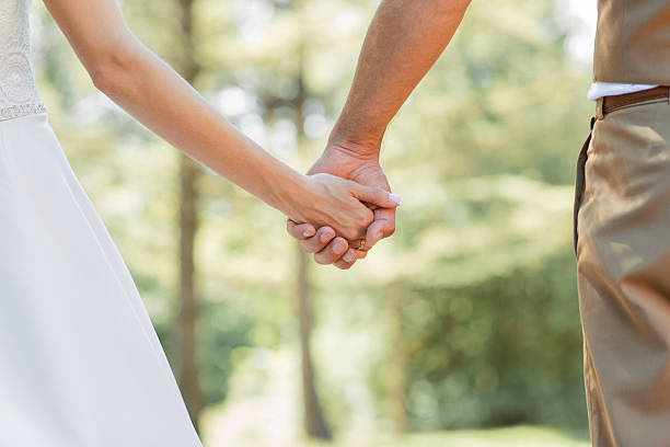istock couple holding hands outdoors 495756878