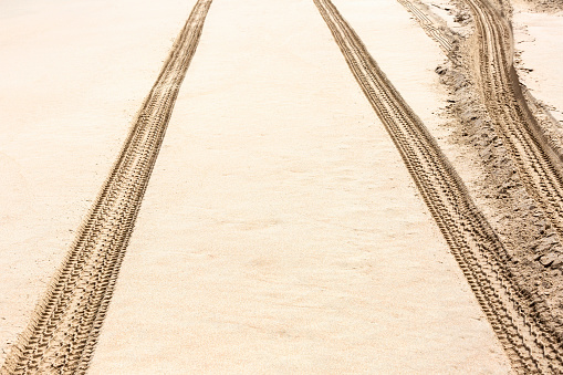 Tyre track on the beach, full frame horizontal composition with copy space