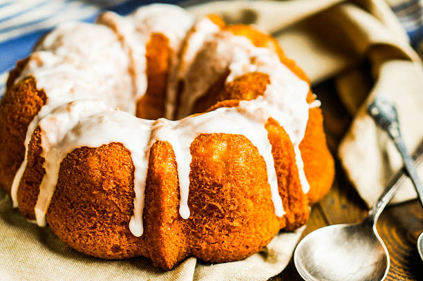 istock Bundt cake with white glaze on rustic background 495757087