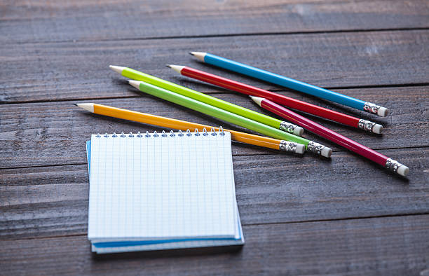 istock Pencils and notebook on wooden table 495757507