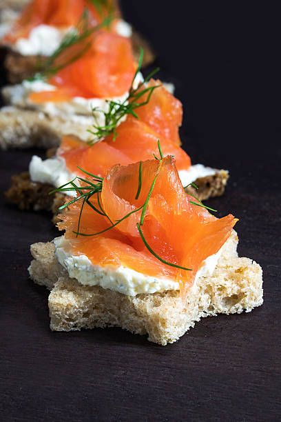 istock canapes in star shape with  salmon on dark wood 495759462