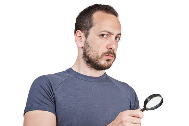 istock Astonished man looking through a magnifying glass 495759757