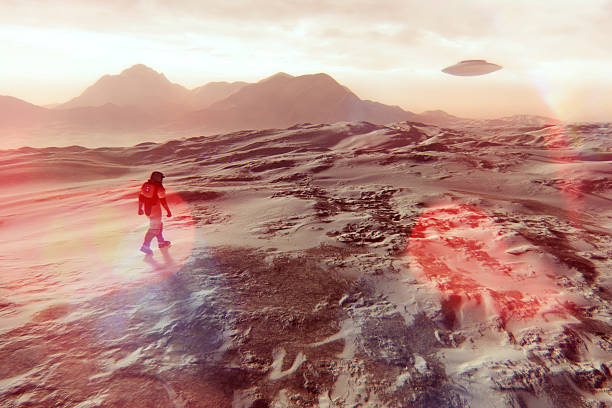 istock Astronaut walking on Martian surface, UFO flying 495760644
